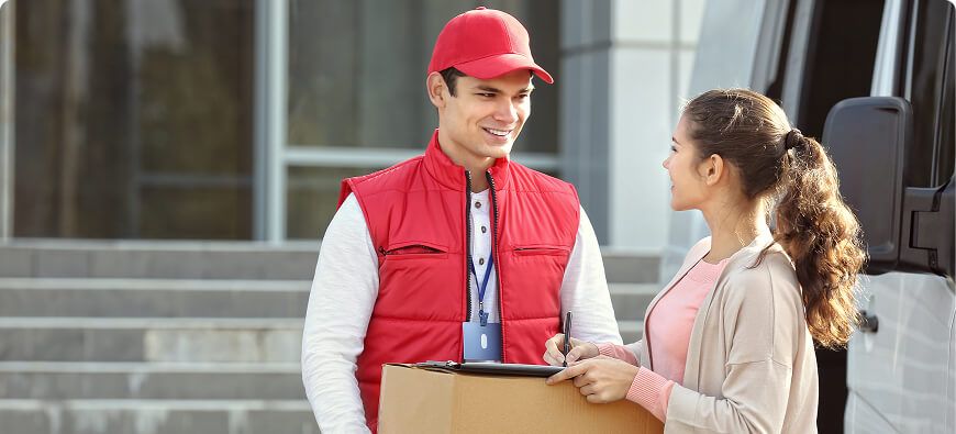Courier handing a parcel to a customer at a delivery van