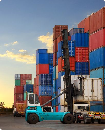 Containers stacked in a port yard with a reach stacker